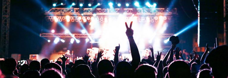 A crowd under the lights of a music festival.