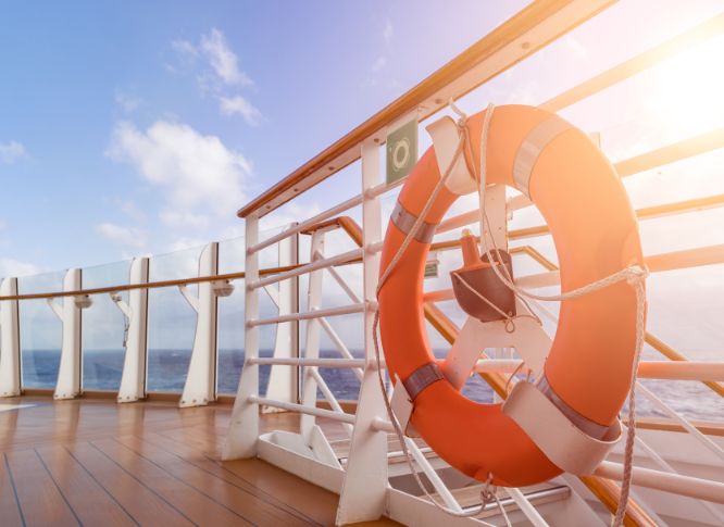 An orange flotation device on the deck of a cruise.