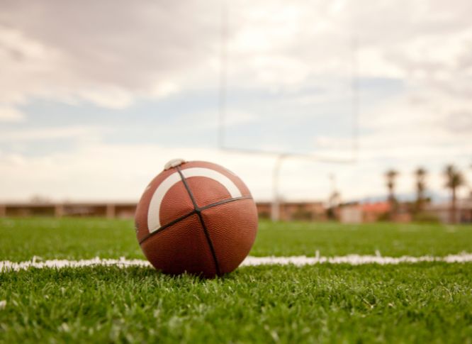 A close-up of a football on a football field.